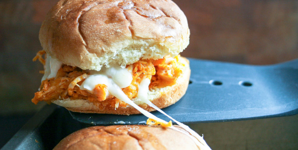 buffalo chicken sliders are made with shredded chicken, wing sauce, seasonings, cheese, and ranch dressing piled onto a slider bun and baked. they're easy, delicious, and perfect for any party! buffalo chicken sliders | a flavor journal